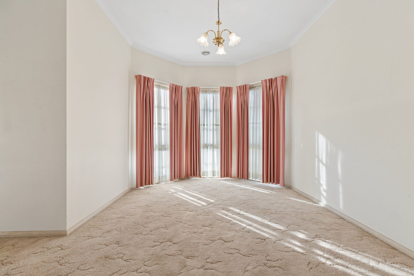 Bay-windowed room beside the kitchen with light falling across the floor