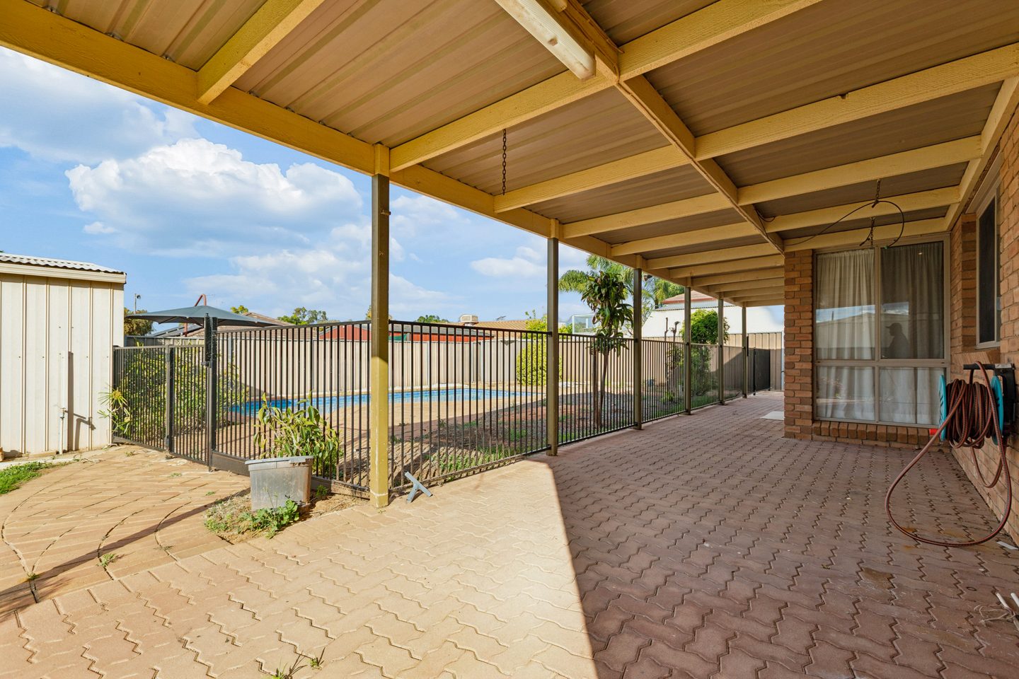 Covered patio overlooking the fenced pool