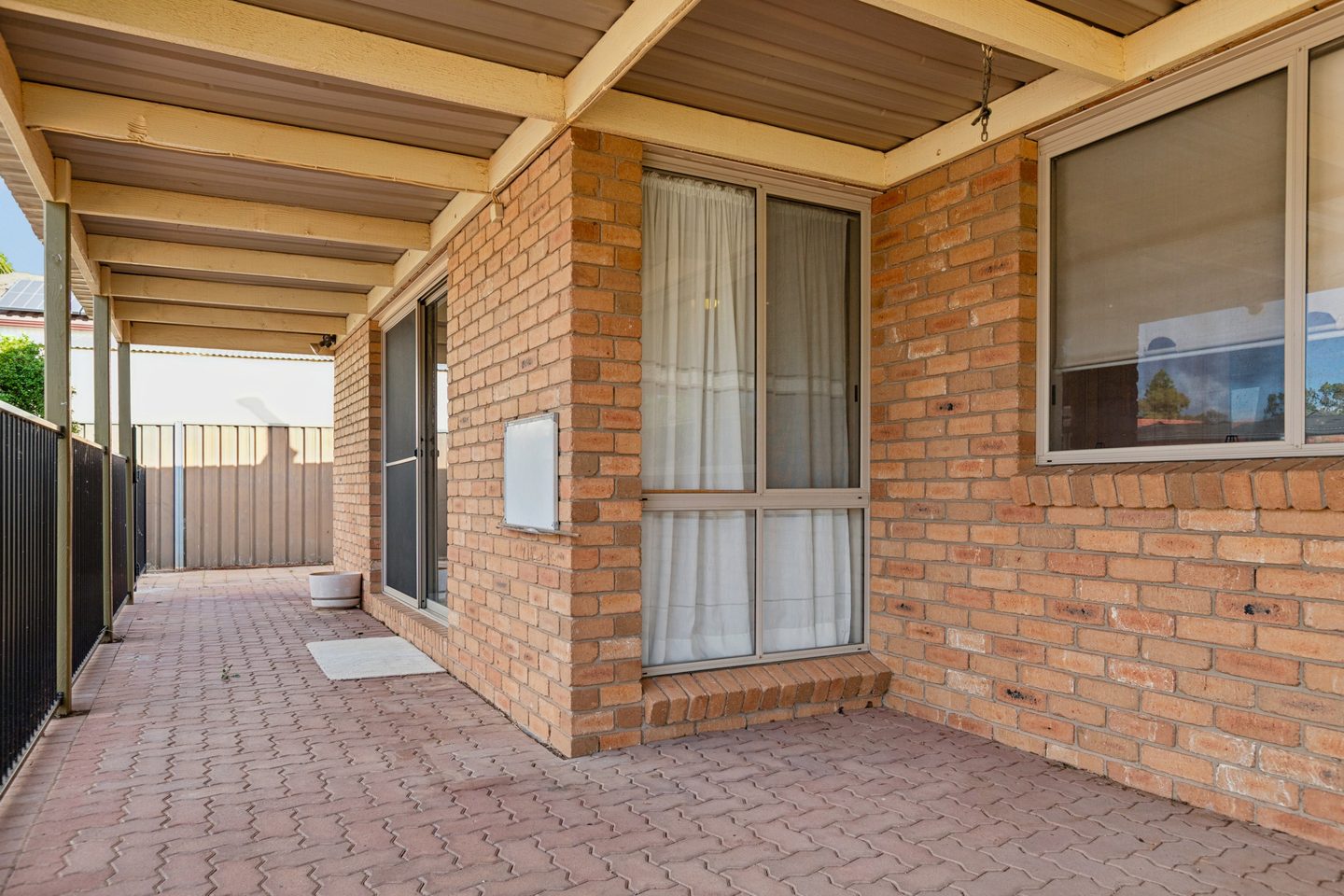 The paved, covered outdoor area